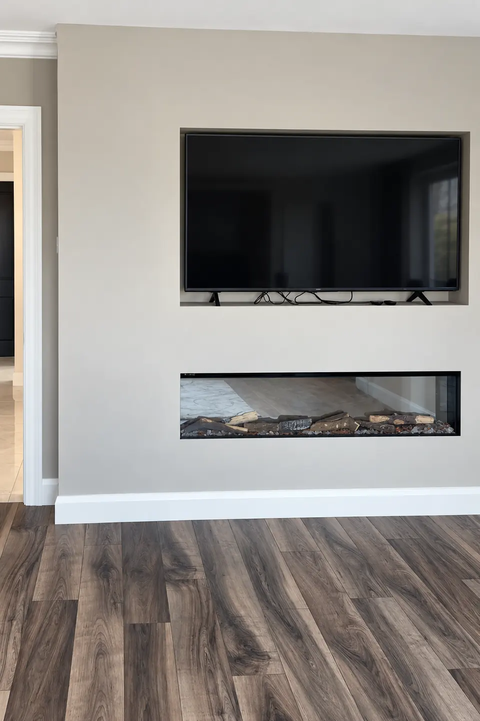 Media wall with inset television, fireplace and timber effect floor